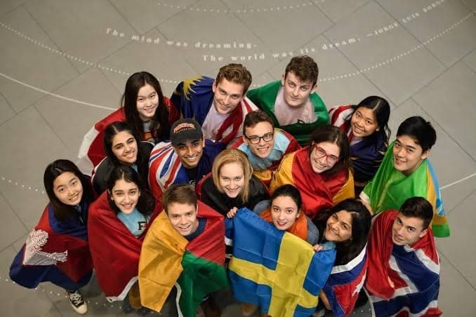 International students wrapped in their national flags